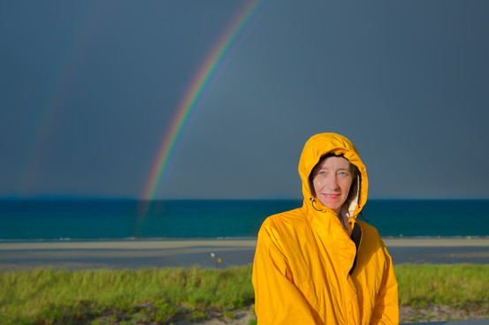 Woman on long beach rainbow