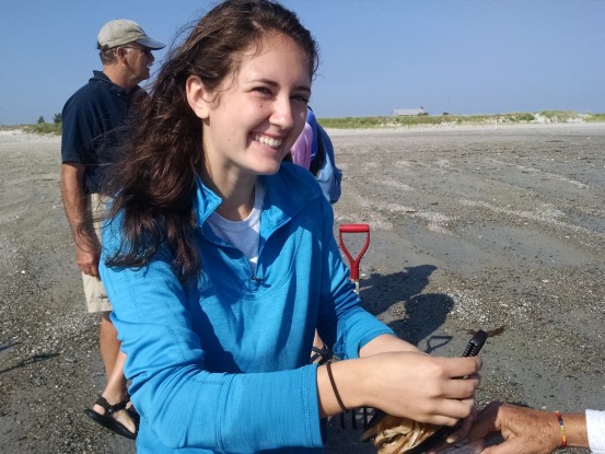 Jordan, a youth volunteer, teaches about clams